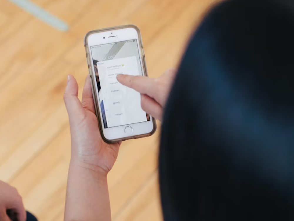 Person using a smartphone to navigate a mobile application - a key aspect of digital strategy consulting is understanding the digital ecosystem